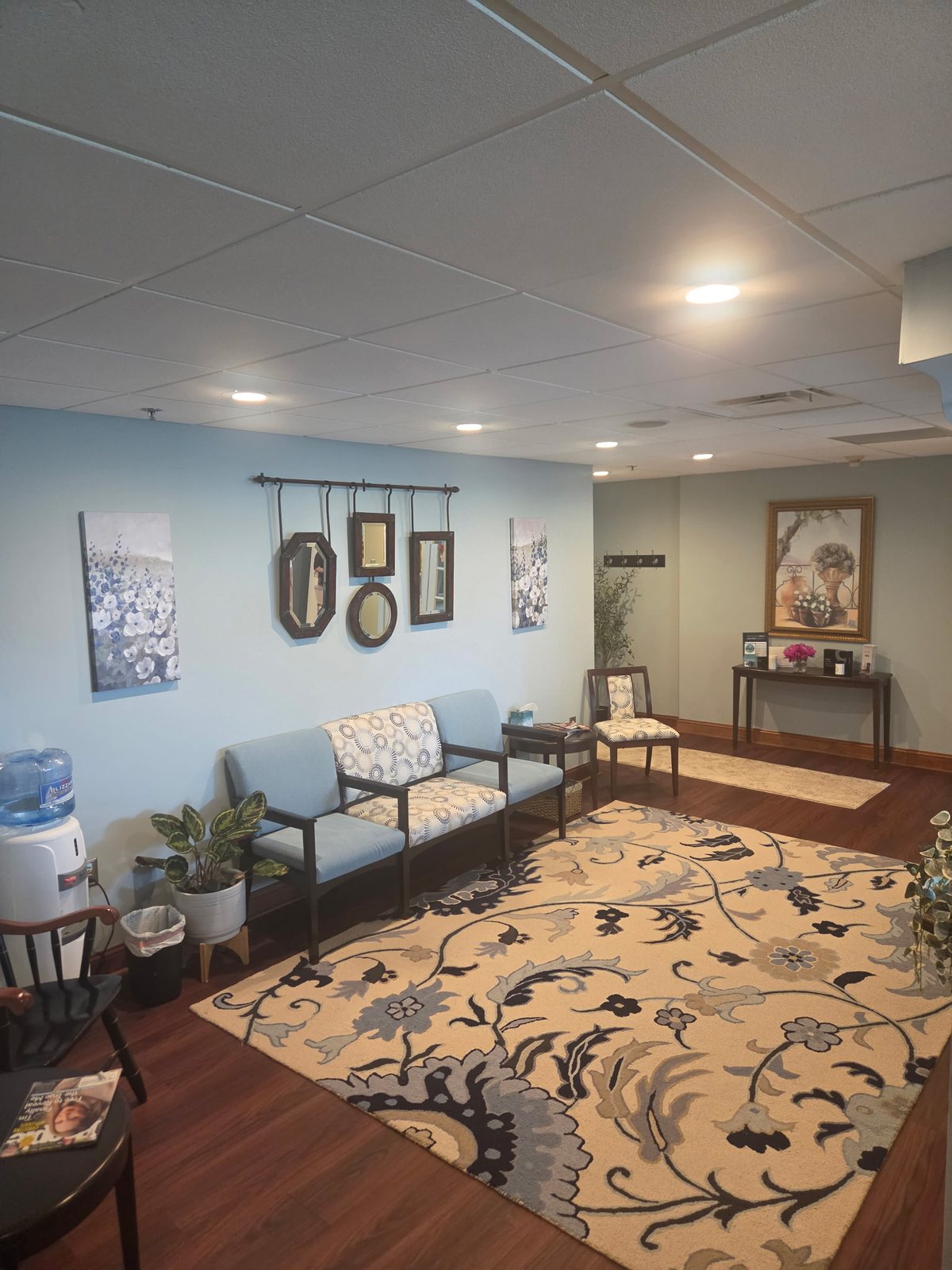 The waiting room seating beneath the mirror wall